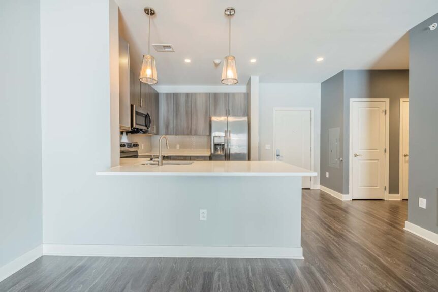 Open-plan modern kitchen with island and pendant lights