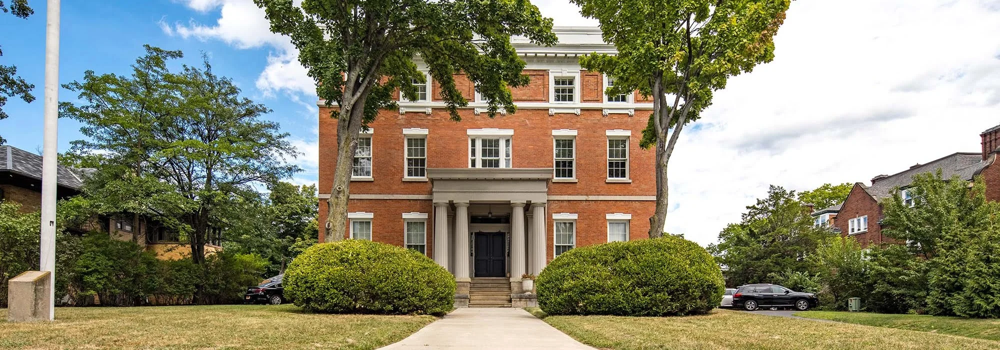 Red brick building with columns and walkway