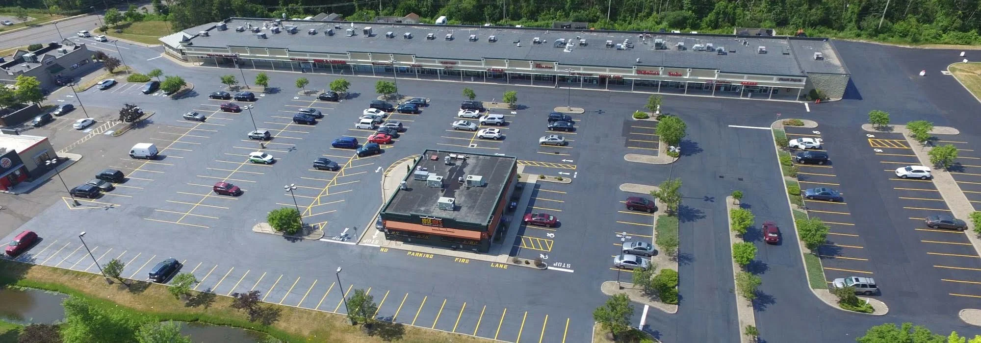 Aerial view of strip mall and parking lot