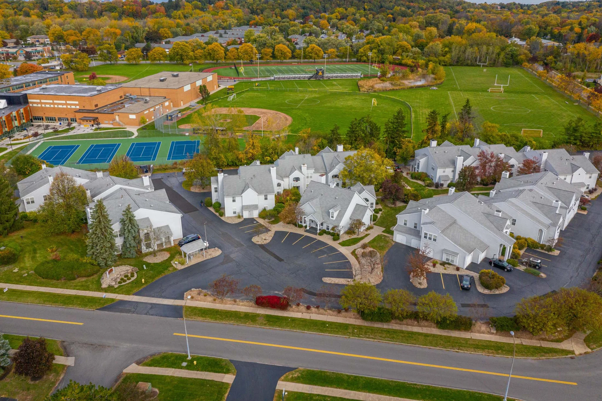 Aerial view of suburban townhouses and school fields